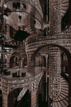 an artistic image of spiral staircases in a building made out of bookshelves