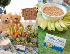 there is a teddy bear sitting at the table with apples, bananas and other foods