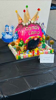 there is a cake that has been decorated with candy and candies on it's table