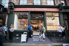 people standing in front of a google home mini store