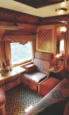 the inside of a train car with couches and windows