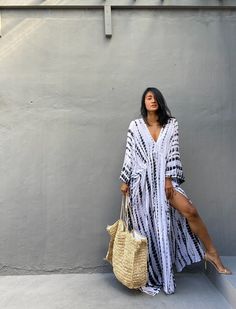 "\"Uluwatu Kaftan dress\" Soft, Smooth, Lightweight Rayon voile Fabric. Perfect for Elegant Day and Nightwear or worn as a cover-up for that beach or poolside statement of glamour. And for Muslim women Color - Hand Tie Dyed White & Black Measurements in CM and Inches. Size American measurement Medium to Large. It fits to all the body size between M to2XL Size - One size fits all American size From S to 2XL Total wide /240cm/94inch(round) Chest & him /180cm/70inch(round) The length /150cm Flowy V-neck Kaftan For Day Out, Hippie V-neck Free Size Maxi Dress, Flowy Boho Sundress For Beach Cover-up, Bohemian V-neck Kaftan For Vacation, Flowy Dresses With Kimono Sleeves For Summer, Flowy Summer Dress With Kimono Sleeves, Bohemian Flowy Loose Maxi Dress, White Free Size Maxi Dress For Beach Cover-up, Hippie Beach Cover-up Dress With Kimono Sleeves