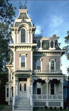 an old victorian style house with many windows and balconies