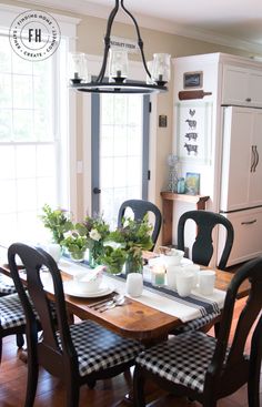 the dining room table is set with black and white checkered place mats on it