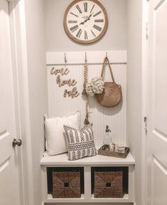 the entryway is decorated with baskets, pillows and a large clock on the wall