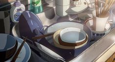 dishes and utensils are sitting on the sink