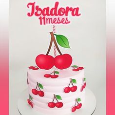 a white cake with cherries on it and the words jsadora mimeses