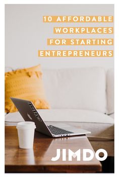 a laptop computer sitting on top of a wooden table next to a cup of coffee