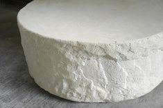 a white round table sitting on top of a wooden floor