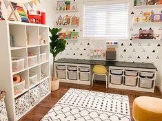 a child's playroom with toys and storage