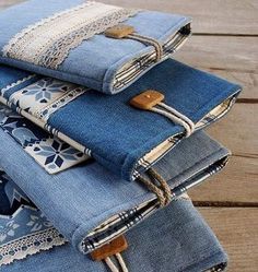 several folded jeans sitting on top of each other