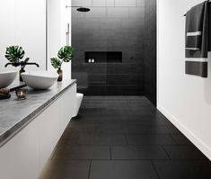 a black and white bathroom with two sinks