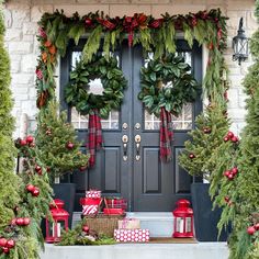 christmas wreaths are hung on the front door