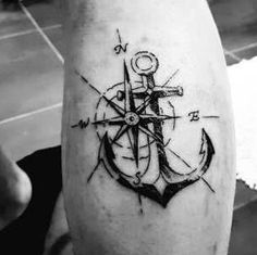 an anchor and compass tattoo on the leg