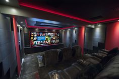 a home theater with black leather seats and red lighting