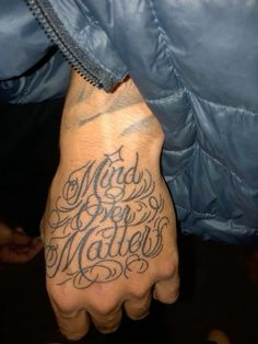 a man with a tattoo on his hand that says mad for mathes written in cursive writing