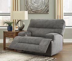 a living room with a gray reclining chair