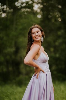 a woman in a purple dress posing for a photo