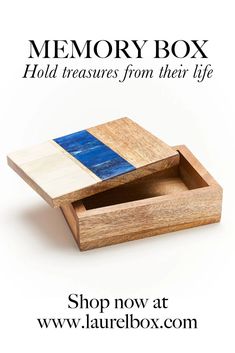 a wooden box with blue and white squares on it, the words memory box hold treasures from their life shop now at www laurellbox com