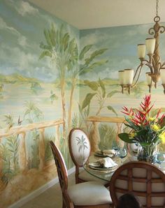 a dining room table with chairs and a chandelier in front of a painting on the wall