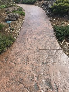 a stone path in the middle of a park