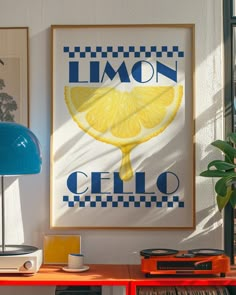 a framed lemon poster hangs on the wall next to a table with records and a lamp