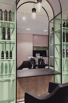 the interior of a salon with green shelves