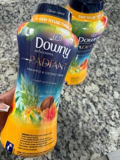 two bottles of douny radiant sitting on a countertop next to each other