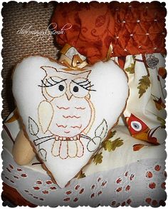 a white heart with an owl embroidered on it