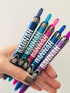 a person holding five pens in their hand with the words hannah written on one of them