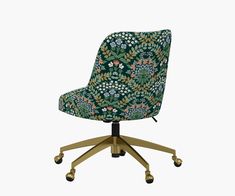 an office chair with wheels and a green floral print upholstered on the back