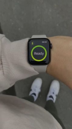 a person wearing an apple watch with the text ready on their screen in front of them