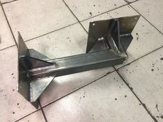 a piece of metal sitting on top of a tiled floor