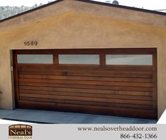 a brown garage door in front of a tan house