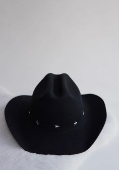 Time to get your howdy on. 100% black Australian wool, paired with an ultra stiff brim. Whether you're searching for stars on the streets of Nashville, or relaxing under them in Jackson Hole, the Dolly is the perfect way to upgrade your look.  Adjustable- Velcro drawstrings under interior band. To perfect/downsize the fit up to 2cm.  10% of proceeds goes to organizations fighting human trafficking Brim- 9 cm Height- 10-11 cm Structure- Stiff Cowgirl Hats Black, Womens Western Hat, Black Cowgirl Hat, Black Felt Cowboy Hat, Womens Western Hats, Texas Hat, Felt Cowboy Hat, Winter Headwear, Black Cowboy Hat