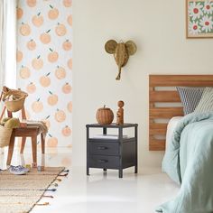 a bed room with a neatly made bed next to a night stand and two small nightstands