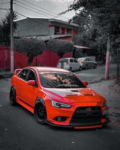 an orange car is parked on the street