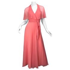 Beautiful 1970s coral pink halter maxi dress / gown with attached sheer caplet! Features a halter neck with two spaghetti straps in the back to offer additional support. Self tied sash belt at left waist. Tailored bodice with a full skirt. Hidden metal zipper up the back with hook-and-eye closures. Very well made, with heavy attention to details. Great for any day or evening event. Perfect with sandals, wedges or flats for day, and heels for evening. In great condition. Made in USA Approxiamtely Vintage Pink Maxi Dress For Evening, Rosa Coral, Pink Silk Dress, 70s Maxi Dress, Vintage Mini Dresses, Seventies Fashion, Halter Maxi Dress, Halter Maxi, Vintage Maxi Dress