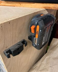 a cordless driller attached to a piece of wood