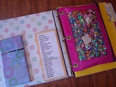 an open binder with lots of colorful beads on it and a notepad in the middle