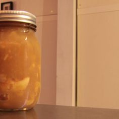 a jar filled with liquid sitting on top of a counter