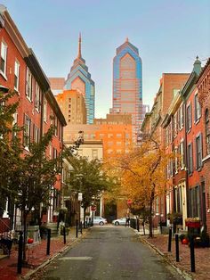 an empty city street with tall buildings in the background