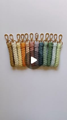 a row of multicolored bracelets with gold clasps hanging from each side