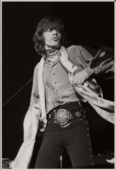 an old photo of a woman in black and white with a scarf around her neck