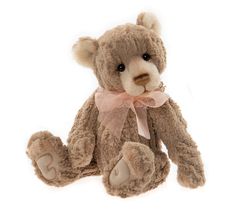 a brown teddy bear with a pink bow on it's head and eyes, sitting against a white background