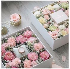 two white boxes with pink and white flowers in them