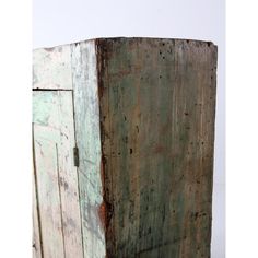 an old wooden cabinet with peeling paint on the doors and bottom part of it's door