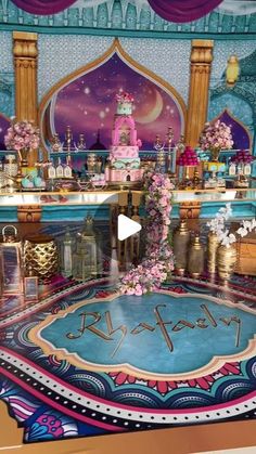 the stage is decorated with pink flowers and gold accents for a princess themed birthday party