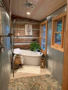 a bathroom with a tub, shower and window in it's center area is shown