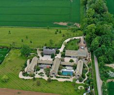 an aerial view of a large house in the countryside